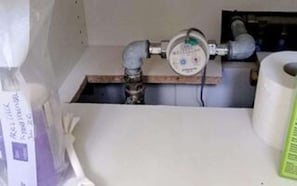 A bathroom with a toilet, a sink, and a visible plumbing setup. - Holiday Home in NykÃ¸bing Sj (Nykobing Sjaelland)