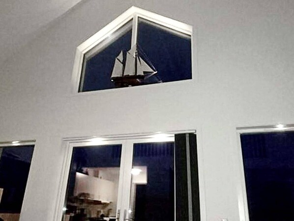 A room with a large window and a smaller window above it, both with white frames. - 4 Star Holiday Home in Stromstad (Stromstad)