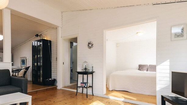 A spacious room with wooden flooring, a bed, a desk, and a chair. - 6 Person Holiday Home in Follenslev (Follenslev)