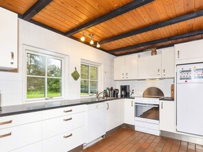A modern kitchen with white cabinets, a stainless steel sink, and a built-in oven. - 6 Person Holiday Home in Bindslev (Bindslev)