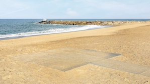 A sandy beach with a rocky breakwater and calm sea. - Pleasing Holiday Home in Vestervig With Terrace (Vestervig)