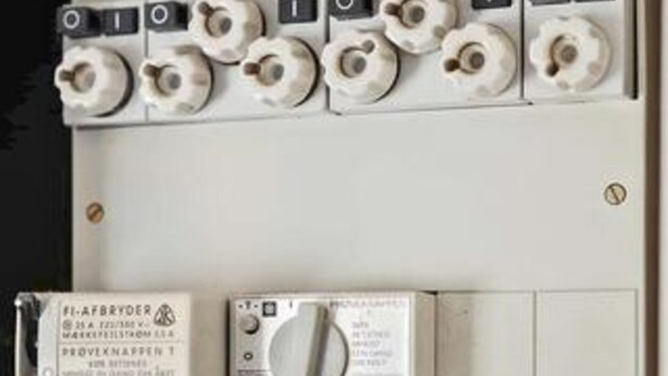 A control panel with multiple switches and a manual. - 5 Star Holiday Home in Fjerritslev (Fjerritslev)