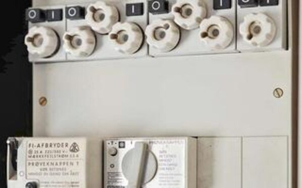 A control panel with multiple switches and a manual.
