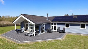 A modern house with a covered patio, solar panels, and a well-maintained lawn. - 5 Star Holiday Home in Fjerritslev (Fjerritslev)