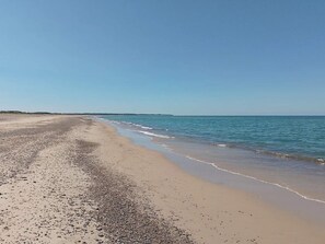A beach with a wide sandy shore and calm sea. - 5 Star Holiday Home in Laeso (Læsø)