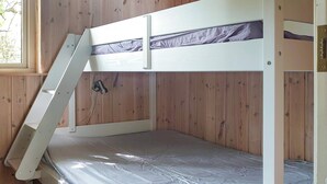 A bunk bed with a ladder, wooden walls, and a window. - 4 Star Holiday Home in Thyholm (Thyholm)