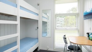 A bunk bed room with a window, a desk, and a chair. - 8 Person Holiday Home in Hjorring (Hjørring)