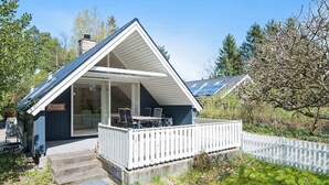 A small, single-story building with a sloped roof and a covered patio area. - 4 Person Holiday Home in Ebeltoft (Ebeltoft)
