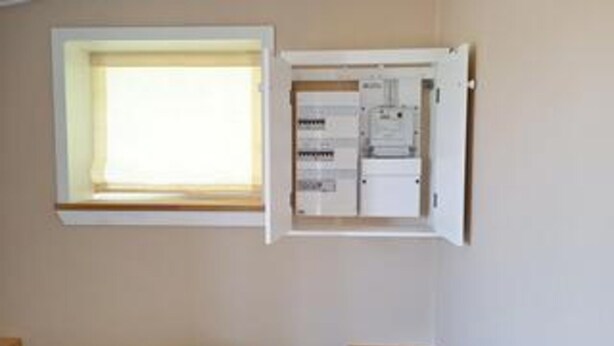 A room with a window, an open electrical panel, and a bed. - 5 Person Holiday Home in Romo (Rømø)