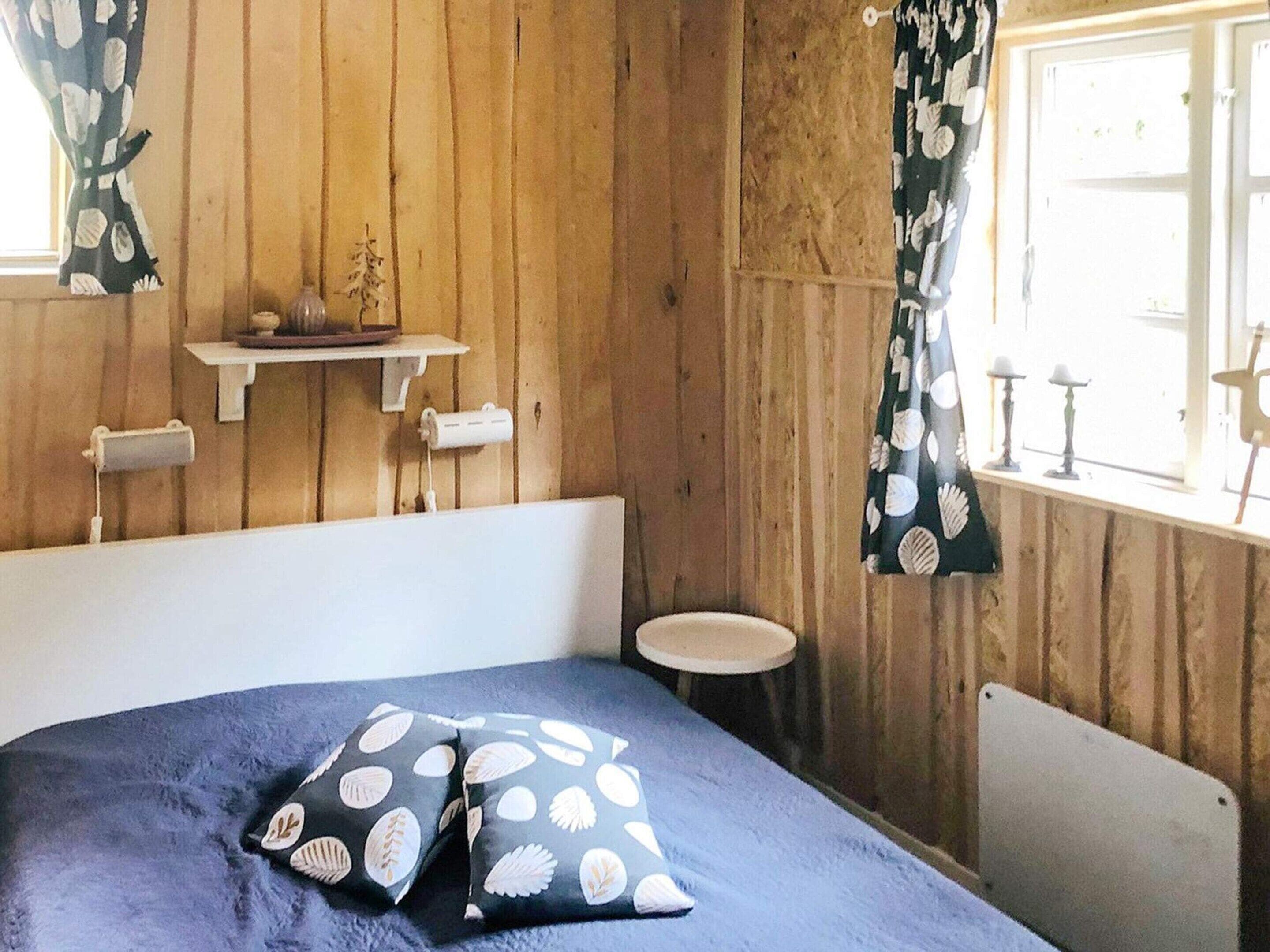 A room with a bed, a small round table, and a radiator.