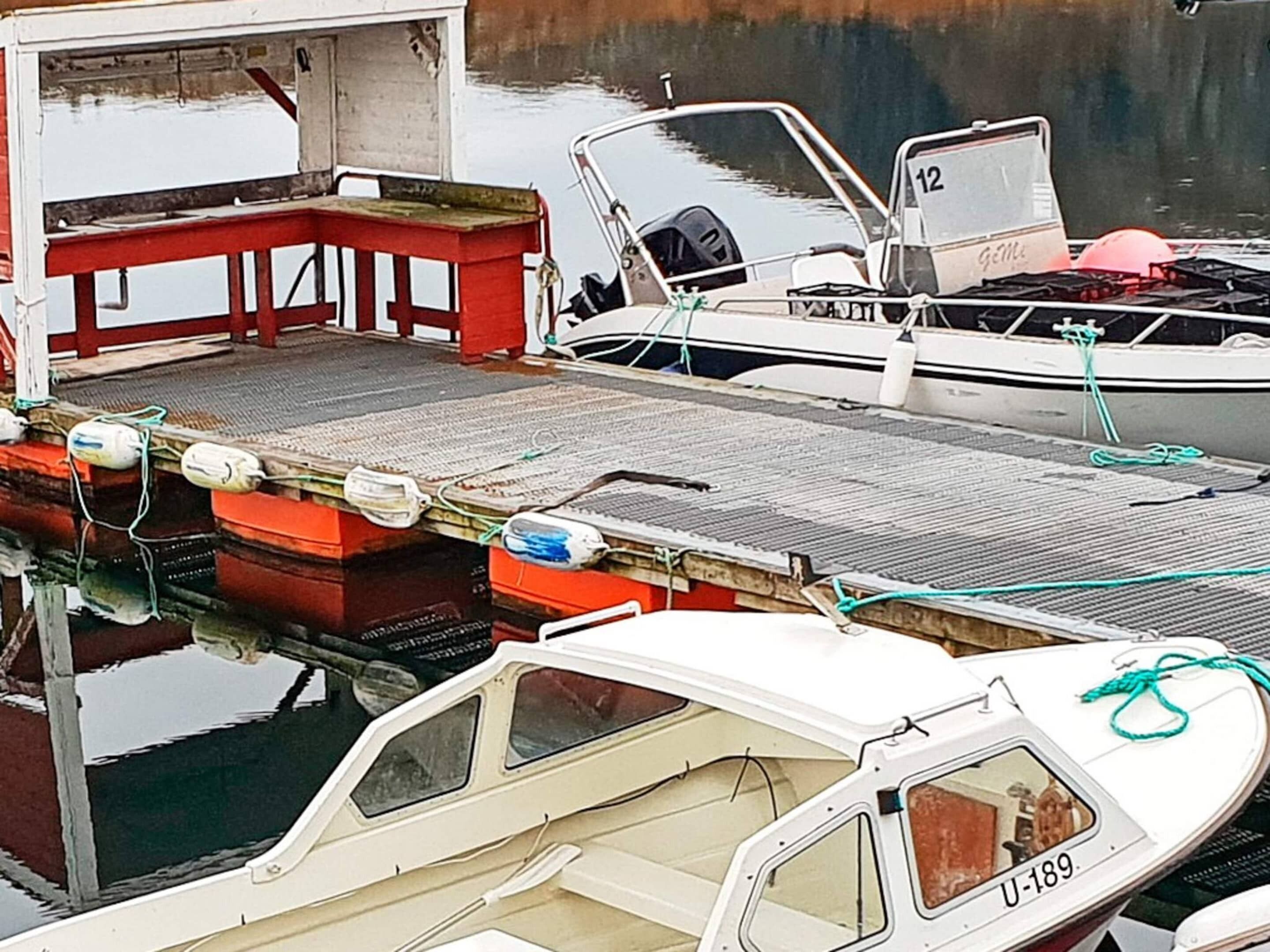 A dock with boats, including a white one with 'U-189' on its side.