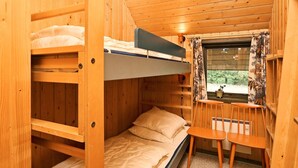 A bunk bed room with a window, a chair, and a small table. - 6 Person Holiday Home in Norre Nebel (Norre Nebel)