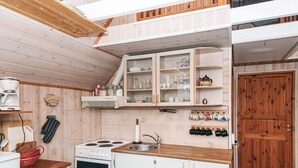 A compact kitchen with white cabinetry, a stove, and a sink. - 5 Person Holiday Home in Grindsted (Grindsted)