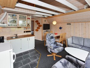 A compact living space with a kitchenette, dining area, and seating.
