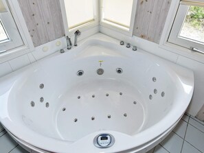 A large, white, freestanding bathtub with multiple faucets and a digital control panel. - Exotic Holiday Home in Nørre Nebel With Sauna (Norre Nebel)