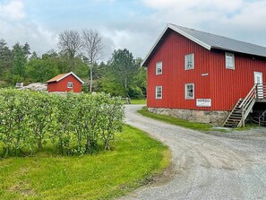 A red barn with a sign reading 'ROSSO' and a smaller red building in the background. - 5 Person Holiday Home in Varekil (Varekil)