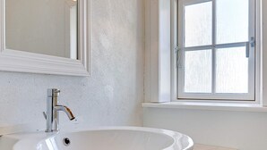 A bathroom with a white sink, a mirror, and a window. - Vintage Holiday Home in Svaneke near Small Harbor (Svaneke)