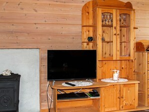 Relax in this inviting room with a flat-screen TV, cabinet, and small table.