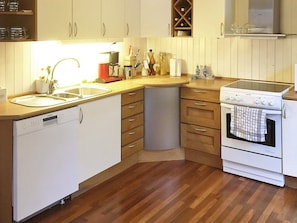 A kitchen with a dishwasher, stove, and sink. - 4 Star Holiday Home in Hovag (Lillesand)