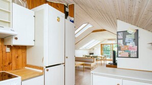 A compact kitchen with white cabinets, a wooden countertop, and a skylight. - 6 Person Holiday Home in Skibby (Skibby)