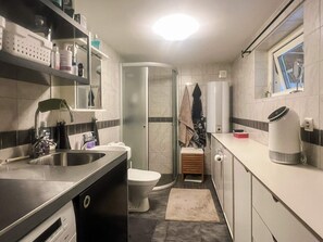 A compact kitchen with a sink, a toilet, and a small window. - 4 Person Holiday Home in Ormaryd (Ormaryd)