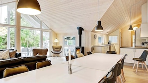 A modern kitchen with a central island, wooden ceiling, and large windows. - 5 Star Holiday Home in Tisvildeleje (Tisvildeleje)