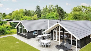 A modern house with a patio, large windows, and a covered outdoor area. - 5 Star Holiday Home in Tisvildeleje (Tisvildeleje)