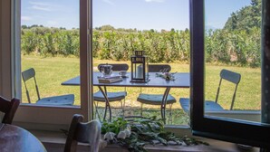 A dining area with a table set for two, a coffee pot, a candle, and a lantern. - Tenuta San Calogero (Augusta)
