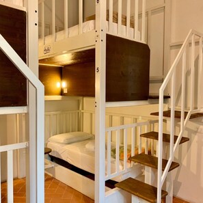 A multi-level bunk bed room with a staircase.