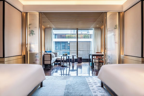 A hotel room with two beds, a balcony with a view, a small table, and a sofa. - Park Hyatt Suzhou (Suzhou)