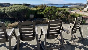 Outdoor seating with a view of a landscaped garden and distant hills. - Ocean, Golf course and Mountain Views.Walk 3/4mi to the beach (Bodega Bay)