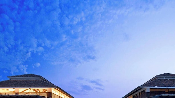 A building with a traditional roof and a clear sky above.