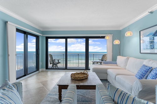 Updated direct oceanfront corner 3/2 with a wrap-around balcony, heated pool and beach access
