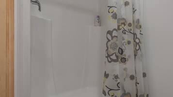 Een douche, handdoeken, zeep, shampoo
