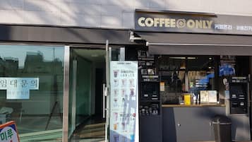 A coffee shop with a glass storefront and a sign reading "COFFEE ONLY".