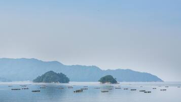A calm body of water with several small islands and boats.