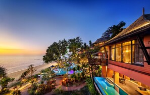 A resort with a pool, outdoor seating, and a view of the beach at sunset. - Nirvana  Beach Resort (Ko Lanta)