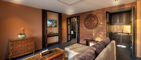 A modern living room with a sofa, coffee table, and decorative items.