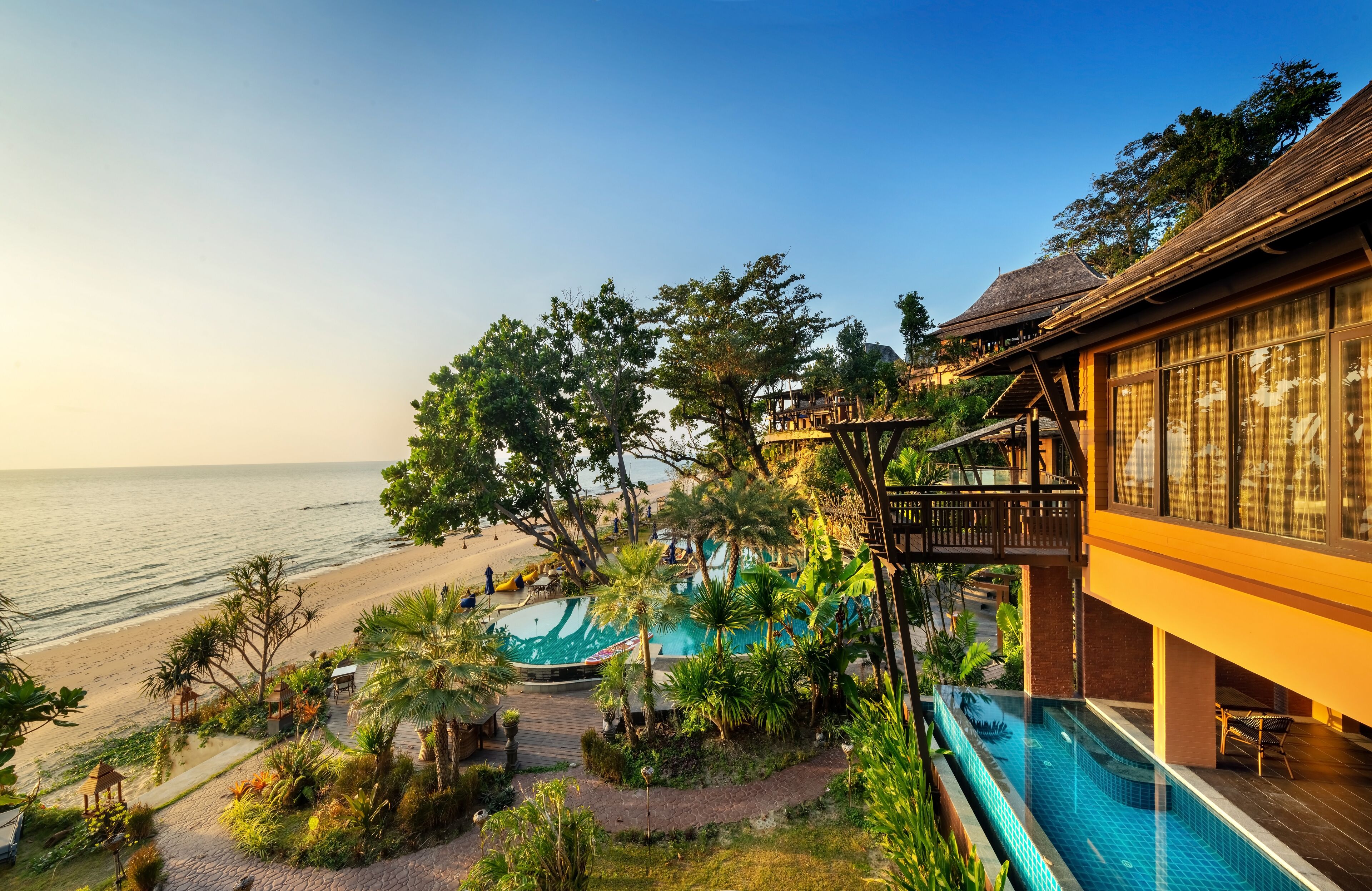 A resort with a pool, beach, and ocean view.