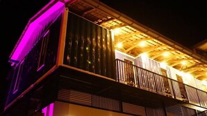 A building with a balcony and a wooden ceiling structure.