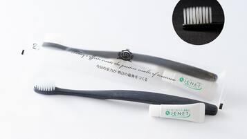 A toothbrush and a tube of toothpaste with text in multiple languages.