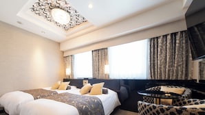 A hotel room with two beds, a sofa, a small table, and a TV. - APA Hotel Ueno Hirokoji (Tokyo)