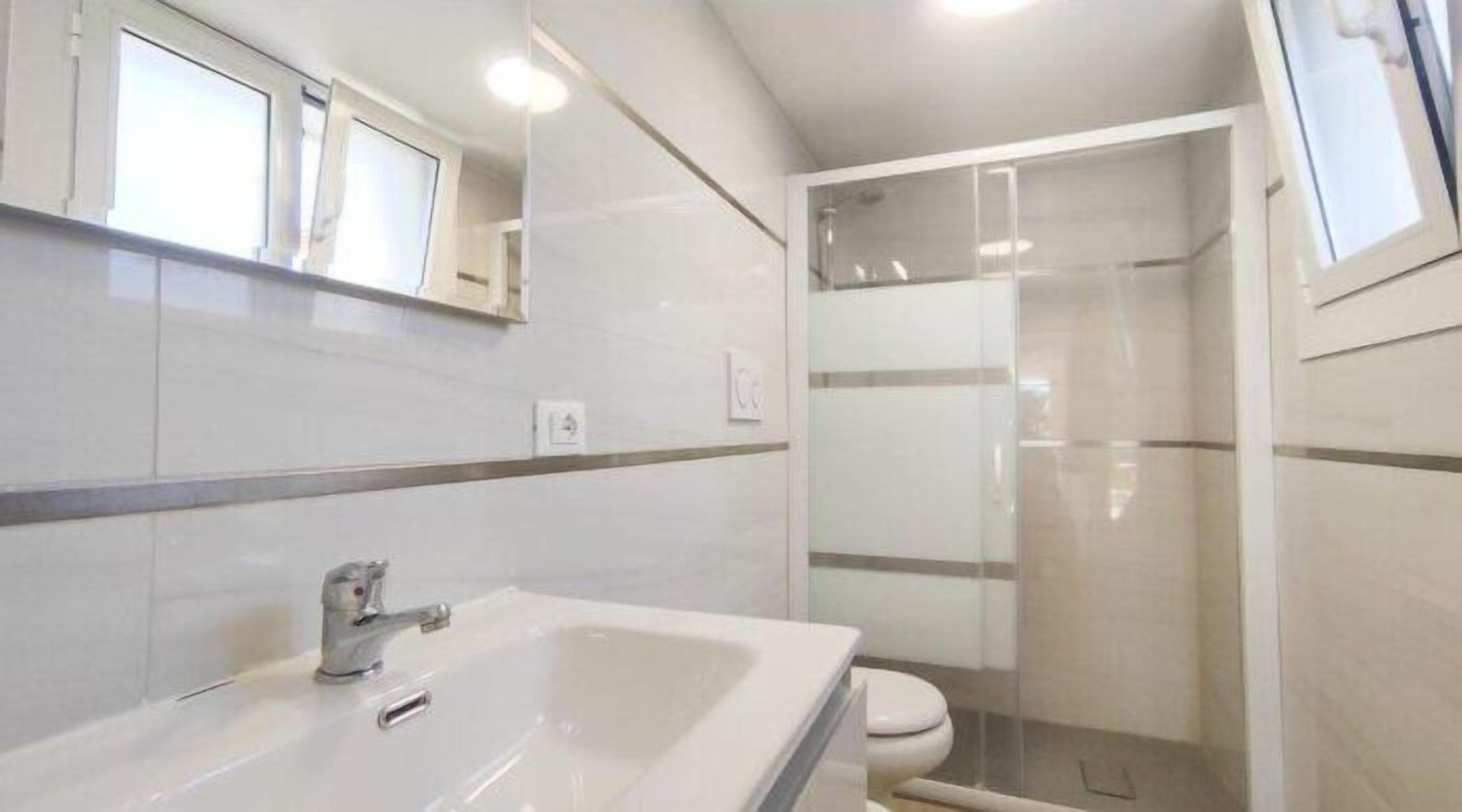 A bathroom with a bathtub, toilet, and shower.