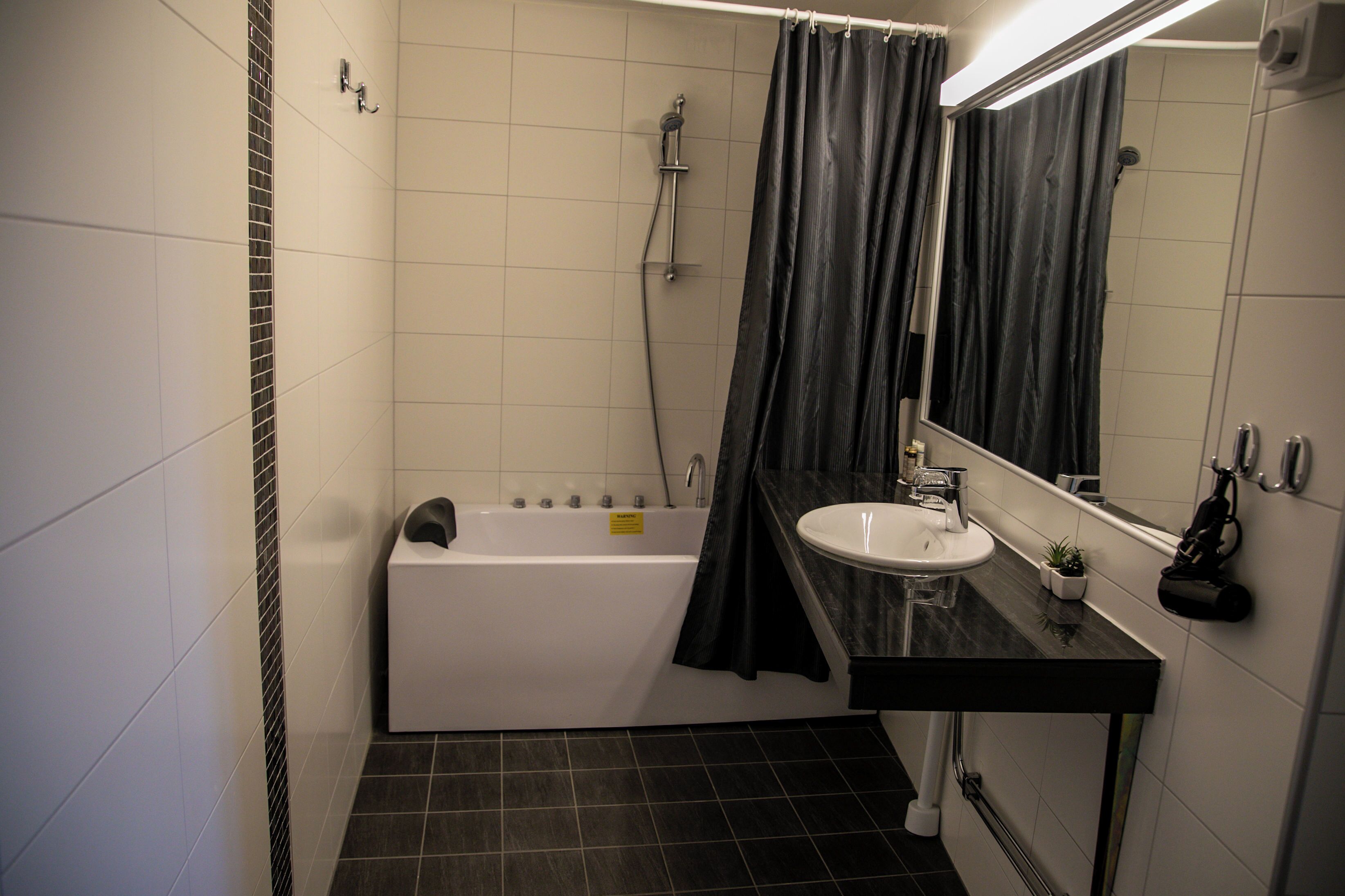 deluxe double room | bathroom | hair dryer, towels, soap, toilet paper