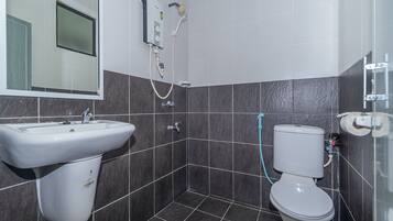 A bathroom with a sink, toilet, and shower.