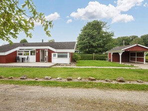 A two-story building with a covered patio and a separate garage. - 6 Person Holiday Home in Bjert-by Traum (Bjert)