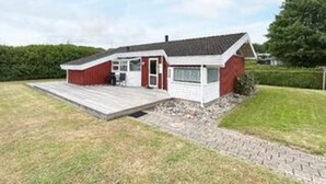 A single-story house with a front porch, a garage, and a small deck. - 6 Person Holiday Home in Bjert-by Traum (Bjert)