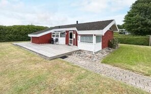 A single-story house with a front porch, a garage, and a small deck. - 6 Person Holiday Home in Bjert-by Traum (Bjert)