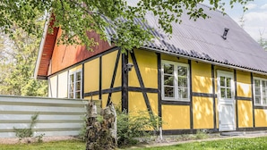 A traditional half-timbered house with a sloped roof, a chimney, and a small porch. - 6 Person Holiday Home in Hals (Hals)