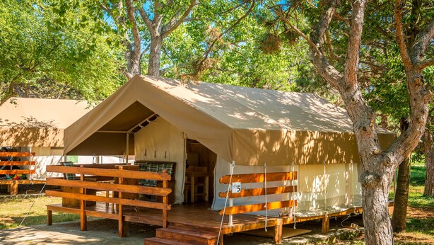 A tented accommodation with a wooden bench and steps leading to the entrance. - Sunflower Camping Savudrija (Umag)